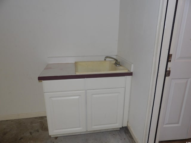 bathroom with vanity and concrete flooring