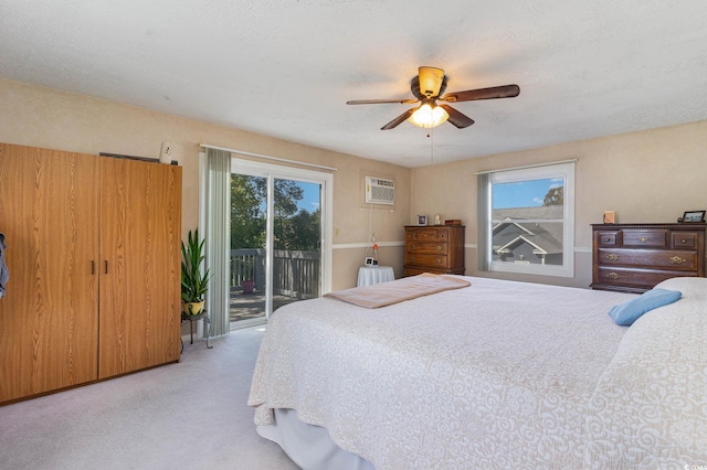 carpeted bedroom with access to exterior, a wall mounted AC, ceiling fan, and radiator