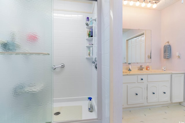 bathroom with a stall shower and vanity