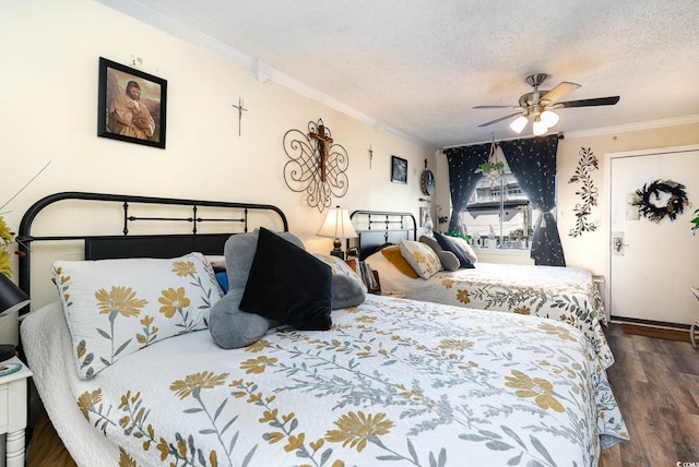 bedroom with dark wood-type flooring, ceiling fan, crown molding, and a textured ceiling