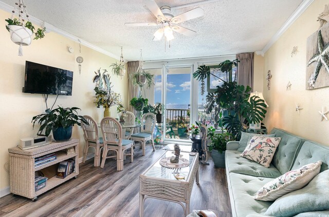 living room with crown molding, a textured ceiling, and wood-type flooring