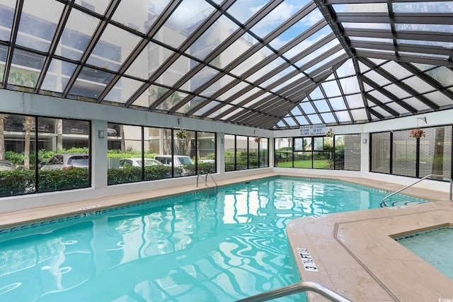 view of swimming pool with glass enclosure