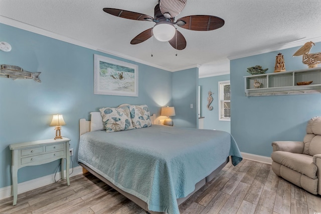 bedroom with crown molding, a textured ceiling, wood-type flooring, and ceiling fan