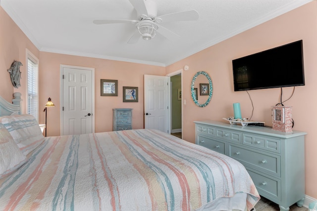 bedroom with ornamental molding and ceiling fan