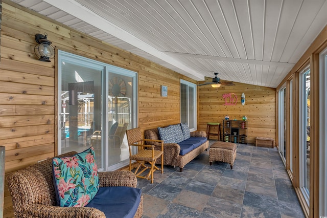 sunroom with lofted ceiling with beams, wood ceiling, and ceiling fan