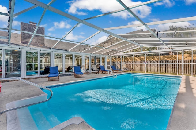 view of swimming pool with a patio and glass enclosure