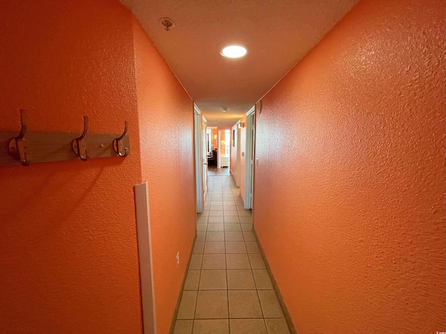 hall with light tile patterned floors