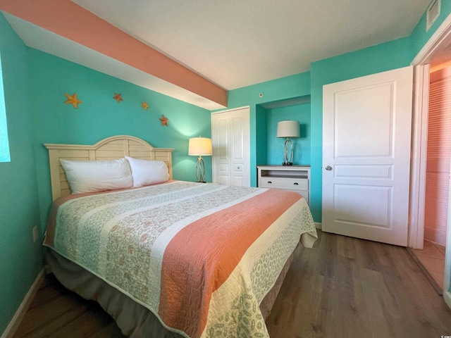 bedroom with a closet and hardwood / wood-style flooring