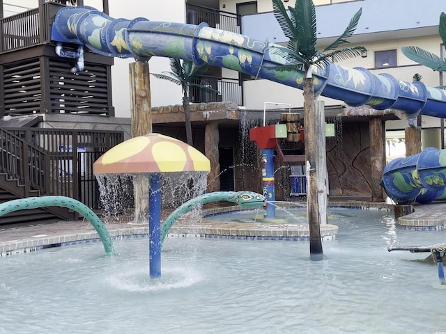 view of swimming pool featuring pool water feature