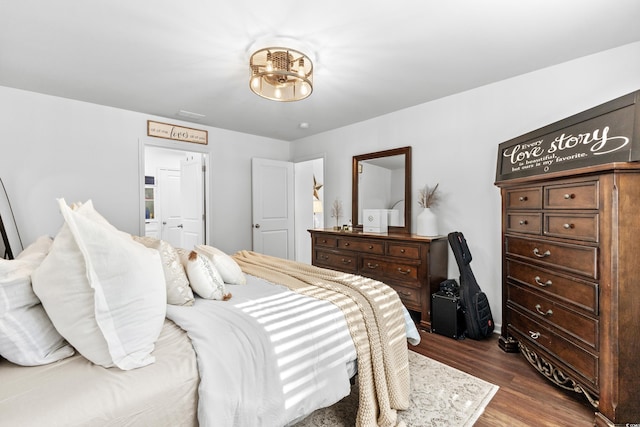 bedroom with dark wood-type flooring