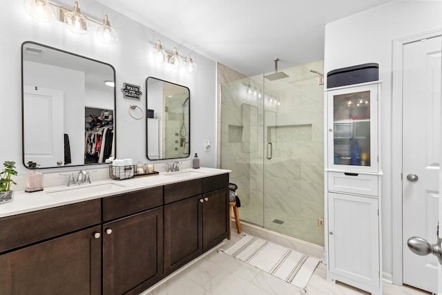 bathroom with vanity and a shower with shower door