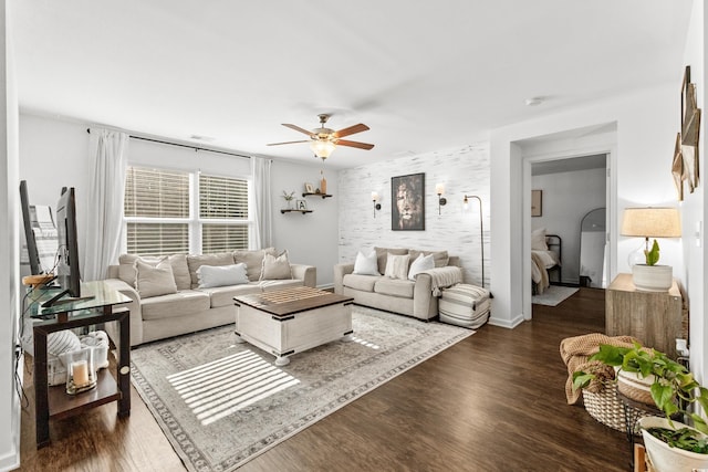 living room featuring ceiling fan and dark hardwood / wood-style floors