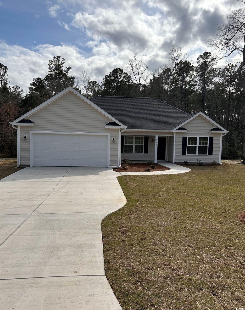 ranch-style home featuring a garage and a front lawn