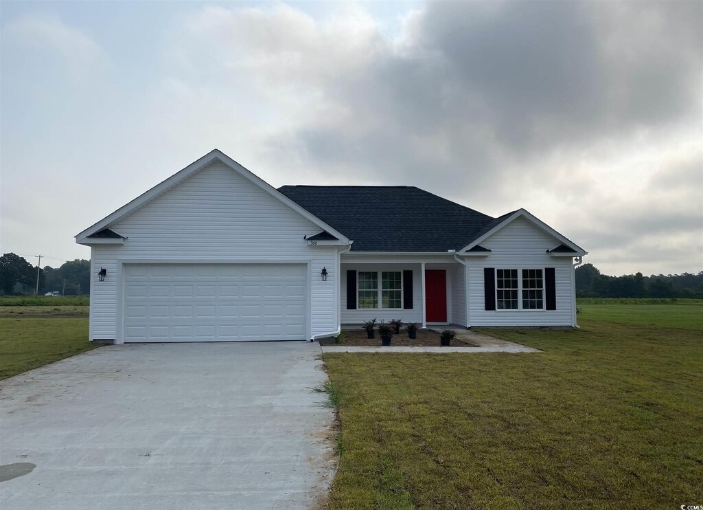 ranch-style home featuring a garage and a front lawn