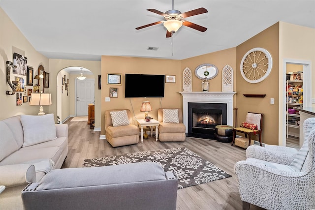 living room featuring ceiling fan and light hardwood / wood-style flooring