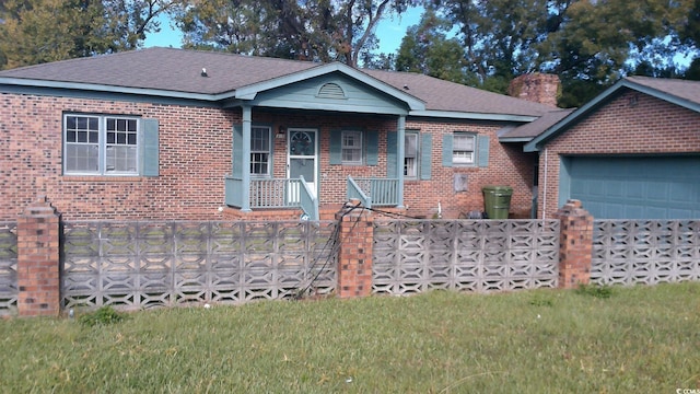 single story home with a front yard and a garage