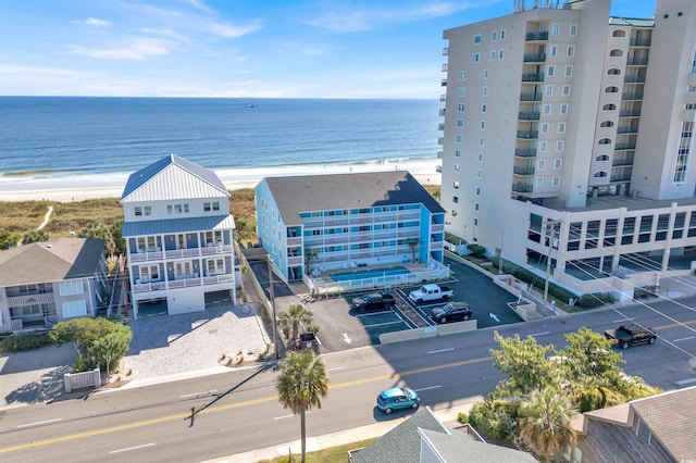 birds eye view of property featuring a beach view and a water view