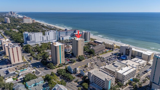 bird's eye view with a water view and a beach view