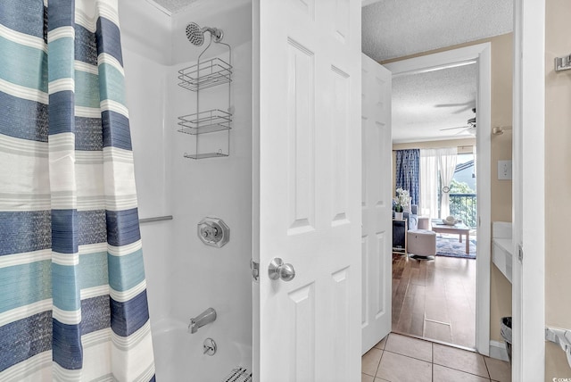 bathroom with shower / tub combo with curtain, a textured ceiling, tile patterned flooring, and ceiling fan