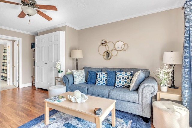 living room with crown molding, hardwood / wood-style flooring, and ceiling fan