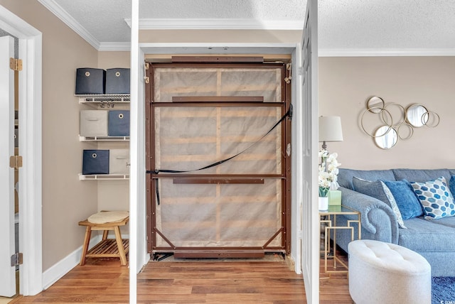 room details with crown molding, wood-type flooring, and a textured ceiling