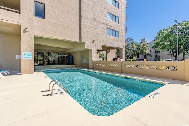 view of swimming pool featuring a patio