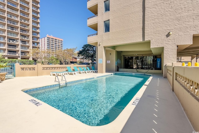 view of pool featuring a patio