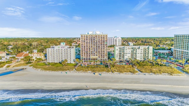 birds eye view of property featuring a water view and a beach view