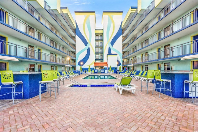 view of pool with an outdoor bar