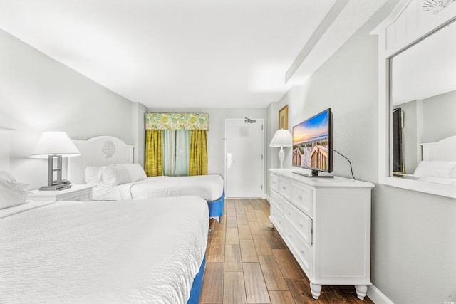 bedroom with dark hardwood / wood-style flooring