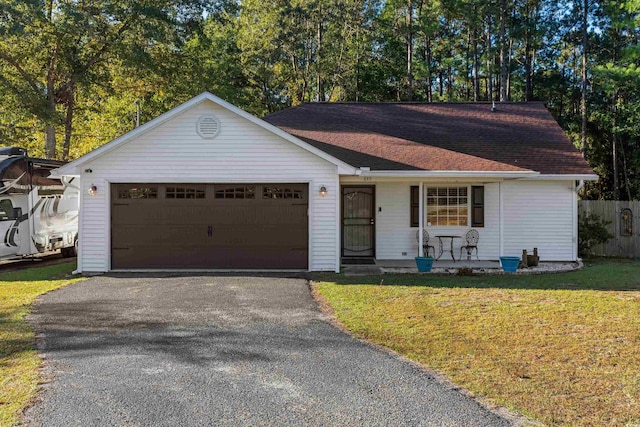 single story home featuring a front yard and a garage