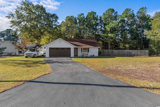 ranch-style house featuring a front yard and a garage