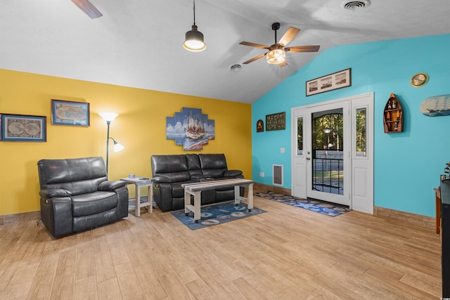 living room featuring ceiling fan, lofted ceiling, and light wood-type flooring