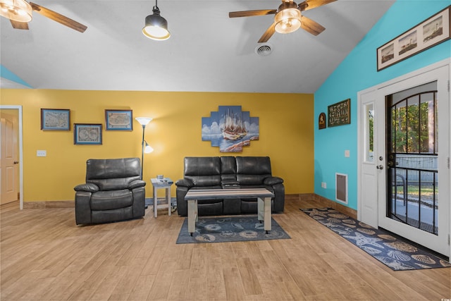 living room featuring light hardwood / wood-style floors, lofted ceiling, and ceiling fan