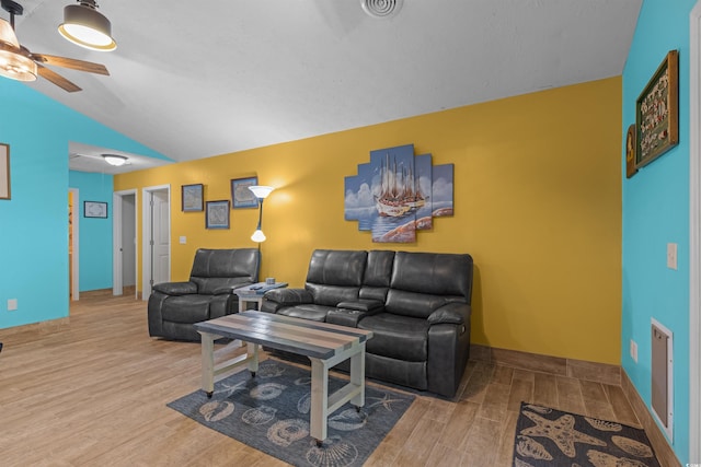 living room with light hardwood / wood-style floors, vaulted ceiling, and ceiling fan