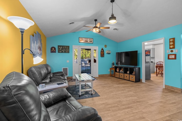 living room with ceiling fan, lofted ceiling, and light hardwood / wood-style flooring