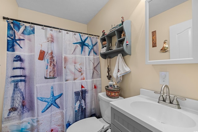 bathroom with vanity, toilet, walk in shower, and a textured ceiling