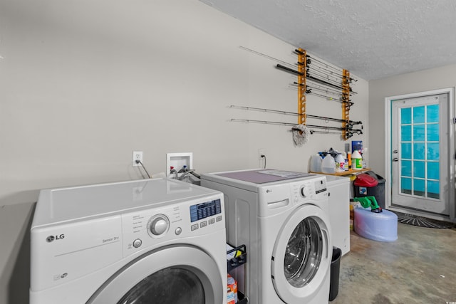 laundry area with washer and dryer and a textured ceiling