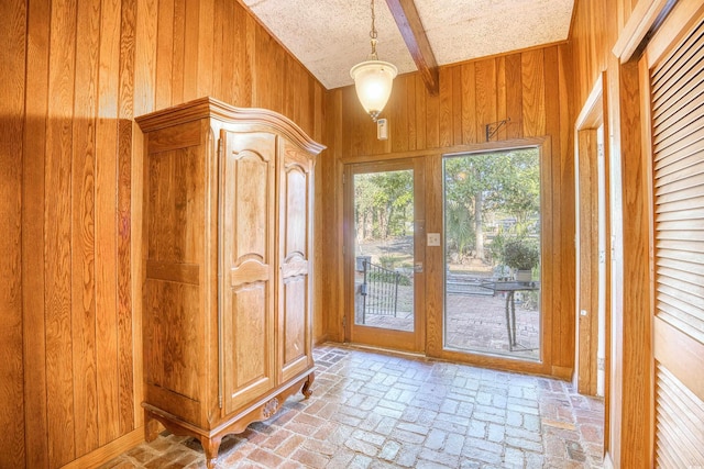 entryway with wood walls