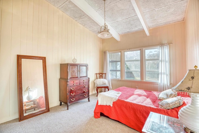 bedroom with beamed ceiling, carpet flooring, and wood walls