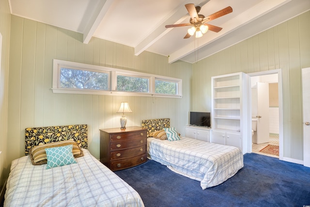 bedroom featuring ceiling fan, connected bathroom, carpet flooring, lofted ceiling with beams, and wooden walls