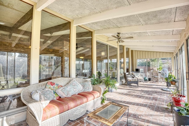 sunroom / solarium featuring vaulted ceiling with beams and ceiling fan