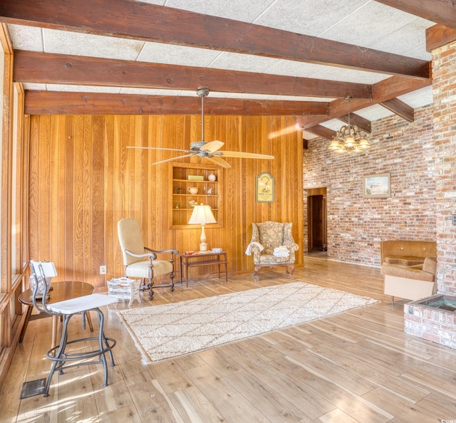 unfurnished room featuring hardwood / wood-style flooring, wooden walls, lofted ceiling with beams, and ceiling fan