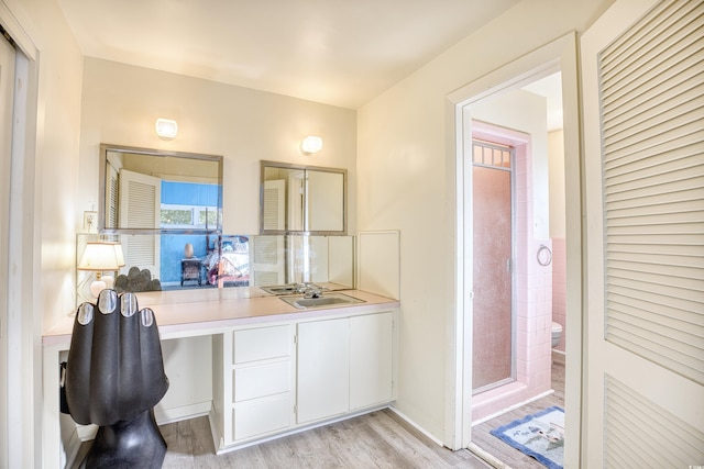 bathroom featuring vanity, walk in shower, toilet, and wood-type flooring