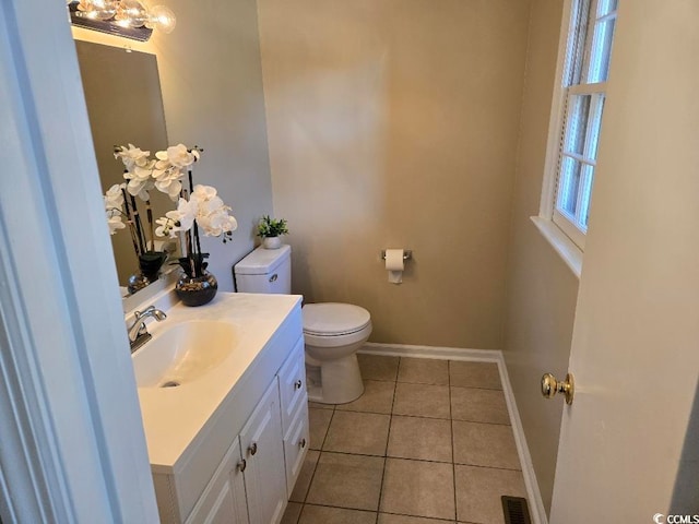 bathroom featuring vanity, tile patterned floors, and toilet