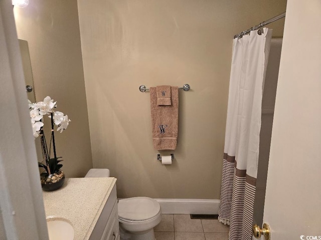 bathroom featuring toilet, vanity, and tile patterned floors