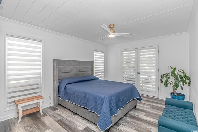 bedroom with wood-type flooring, ceiling fan, ornamental molding, and wood ceiling