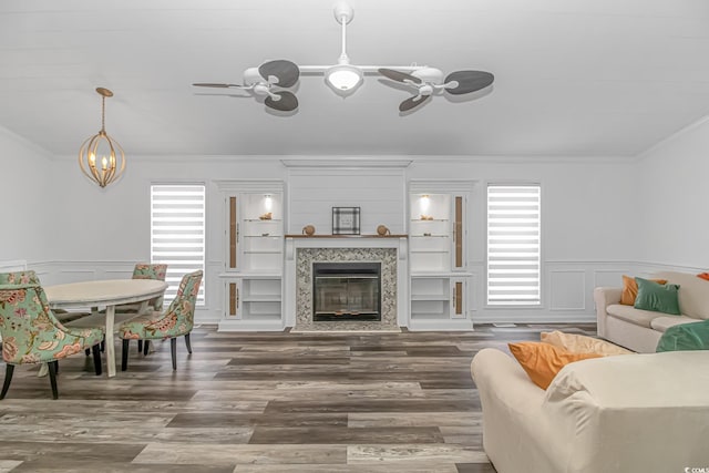 living room featuring ornamental molding and dark wood-type flooring