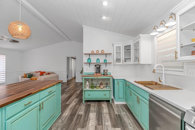 kitchen with white cabinets, sink, hanging light fixtures, vaulted ceiling, and stainless steel dishwasher