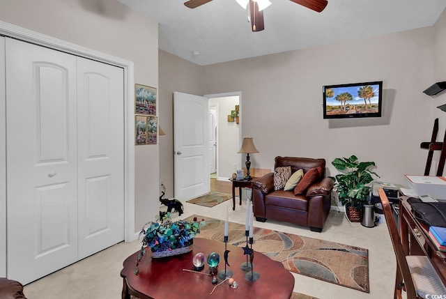 carpeted living room featuring ceiling fan